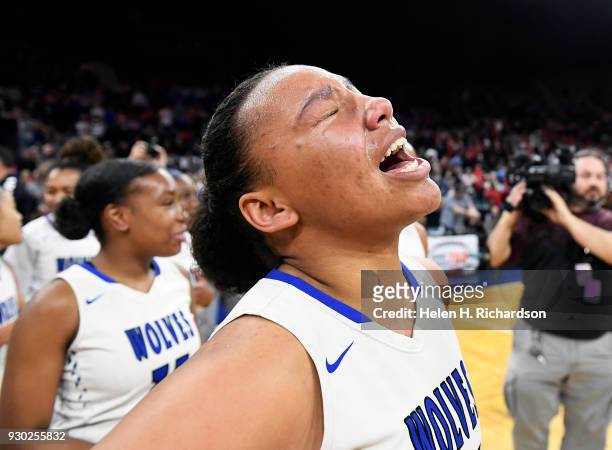 Grandview Wolves' forward Leliah Vigil cries on the court after she and her team beat the Regis Jesuit Raiders to win the 5A girls state championship...