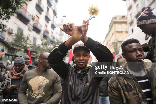 Woman with flowers during the demonstration that took place in Naples against racism and for Idy Diene, a Senegalese street vendor killed in Florence.
