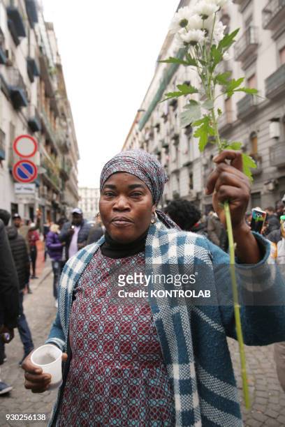Woman with flowers during the demonstration that took place in Naples against racism and for Idy Diene, a Senegalese street vendor killed in Florence.