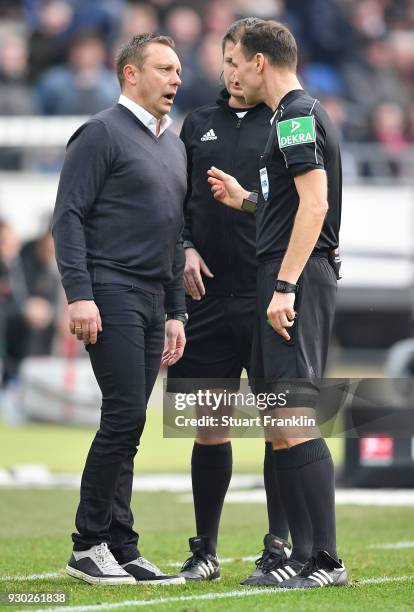 Andre Breitenreiter, head coach of Hannover talks with referee Bastian Dankert during the Bundesliga match between Hannover 96 and FC Augsburg at...