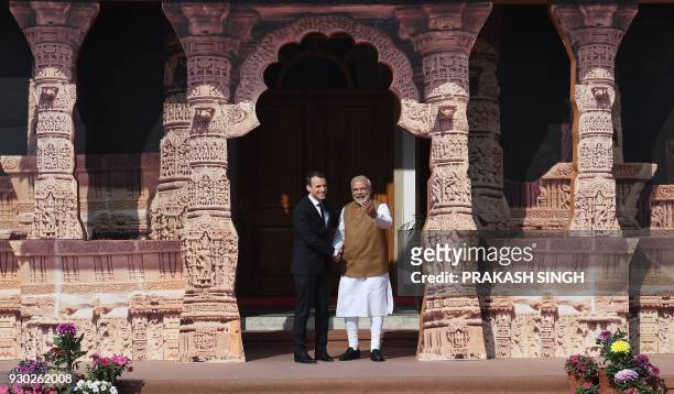 Indian Prime Minister Narendra Modi welcomes French President Emmanuel Macron to the founding conference of the International Solar Alliance in New...