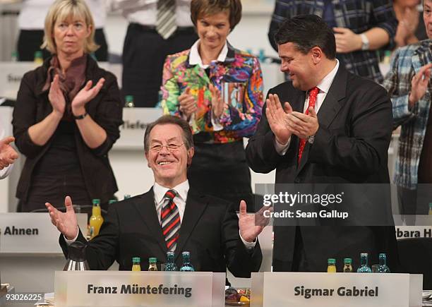 Sigmar Gabriel , new Chairman designate of the German Social Democratic Party , applaudes outgoing Chairman Franz Muentefering after Muentefering's...