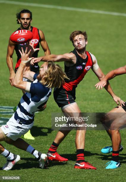 Martin Gleeson of the Bombers sustains a leg injury when landing in this contest for the ball against Cameron Guthrie of the Cats during the JLT...