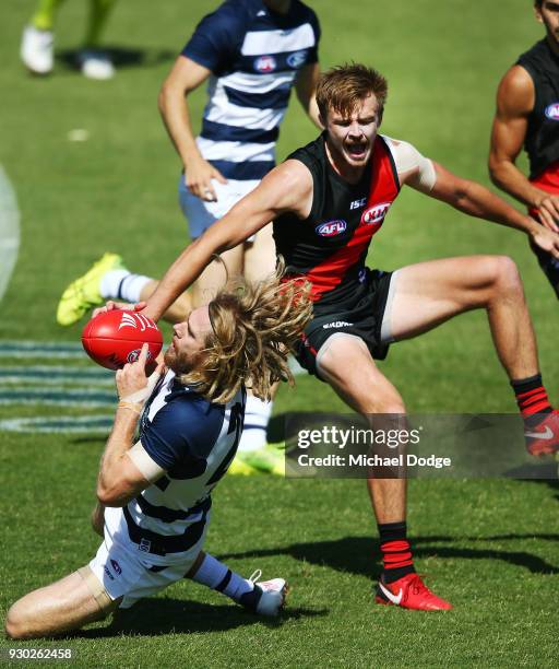 Martin Gleeson of the Bombers sustains a leg injury when landing in this contest for the ball against Cameron Guthrie of the Cats during the JLT...