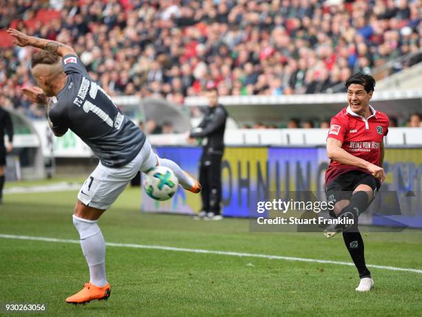 Miiko Albornoz of Hannover is challenged by Jonathan SchmidÊof Augsburg during the Bundesliga match between Hannover 96 and FC Augsburg at HDI-Arena...