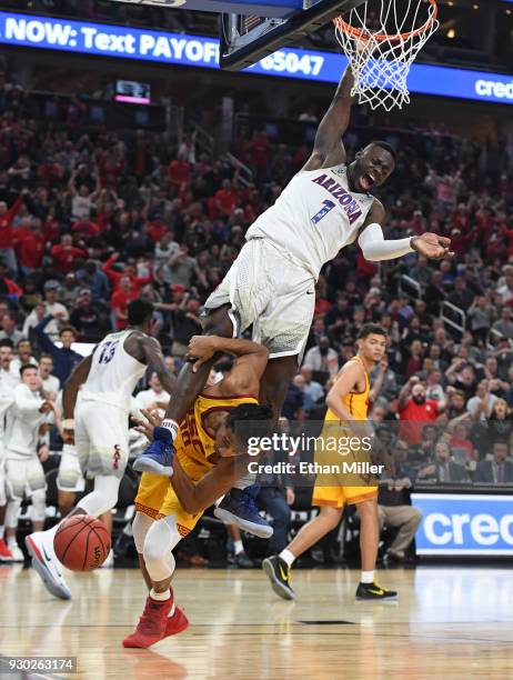 Rawle Alkins of the Arizona Wildcats dunks against Elijah Stewart of the USC Trojans during the championship game of the Pac-12 basketball tournament...