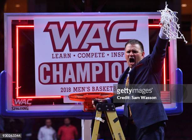 Head coach Chris Jans of the New Mexico State Aggies hold up the net after defeating the Grand Canyon Lopes 72-58 in the championship game of the...