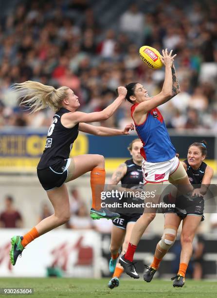 Tegan Cunningham of the Demons is challenged by Breann Moody of the Blues during the round six AFLW match between the Carlton Blues and the Melbourne...