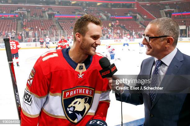 Chats with Jonathan Huberdeau of the Florida Panthers prior to the start of the game against the Montreal Canadiens at the BB&T Center on March 8,...