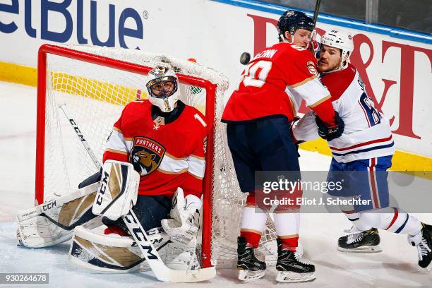 Goaltender Roberto Luongo of the Florida Panthers defends the net with the help of teammate Jared McCann against Andrew Shaw of the Montreal...