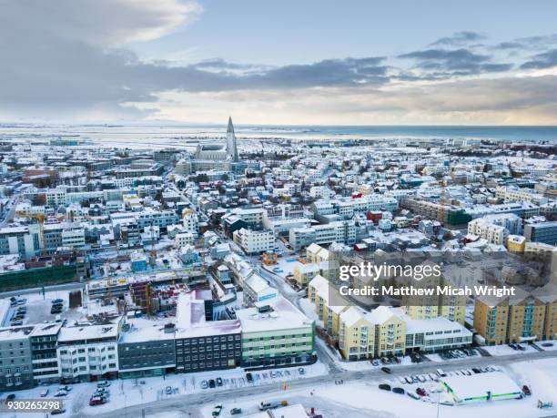 views over the city center of reykjavik. the famed hallgrímskirkja church rises above the surrounding buildings. - reykjavik hallgrimskirkja stock pictures, royalty-free photos & images