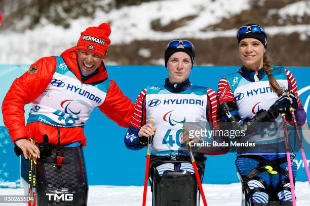 Andrea Eskau of Germany second place, Kendall Gretsch of the United States first place and Oksana Masters of the United States third place pose for...