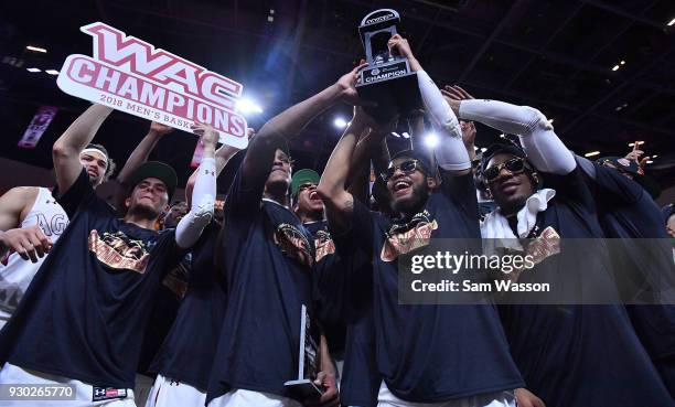 The New Mexico State Aggies celebrate with the trophy after defeating Grand Canyon Lopes 72-58 in the championship game of the Western Athletic...