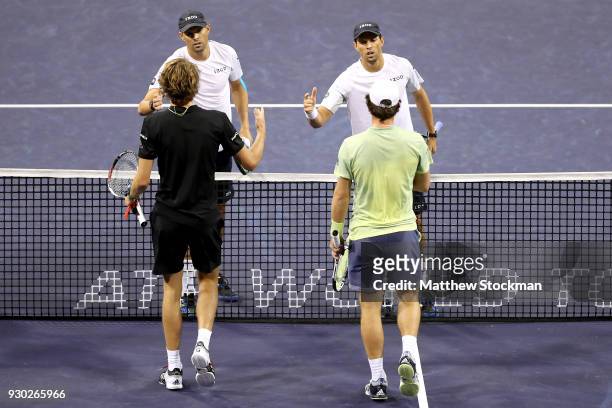 Bob Bryan and Mike Bryan are congratulated by Alexander Zverev and Mischa Zverev of Germany after their match during the BNP Paribas Open at the...