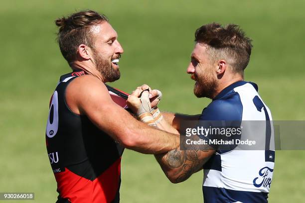 Cale Hooker of the Bombers wrestles Zach Tuohy of the Cats during the JLT Community Series AFL match between the Geelong Cats and the Essendon...
