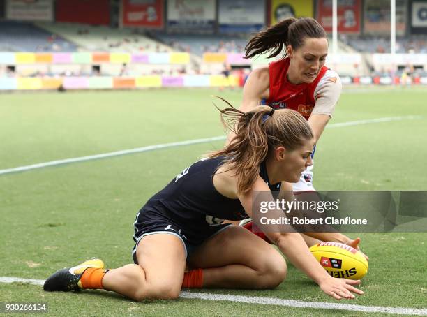 Madeline Keryk of the Blues is pressured by Meg Downie of the Demons during the round six AFLW match between the Carlton Blues and the Melbourne...