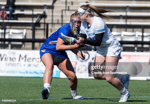 Johns Hopkins Mackenzie Heldberg cut around Hofstra Darcie Smith during a women's college Lacrosse game between the Johns Hopkins Blue Jays and the...