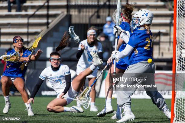 Johns Hopkins Emily Kenul scores past Hofstra Maddie Fields during a women's college Lacrosse game between the Johns Hopkins Blue Jays and the...