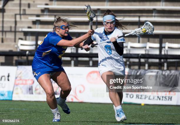 Hofstra Darcie Smith checks Johns Hopkins Maggie Schneidereith during a women's college Lacrosse game between the Johns Hopkins Blue Jays and the...