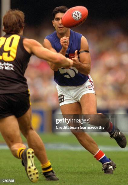 Jose Romero of the Western Bulldogs handballs to a team mate, during the match between the Richmond Tigers and the Western Bulldogs, during round two...