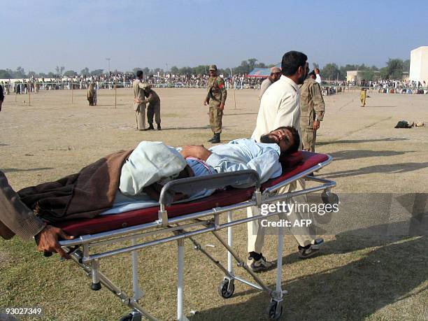 Pakistani volunteers push a stretcher carrying a sick internally displaced tribesman, fleeing from military operations against Taliban militants in...