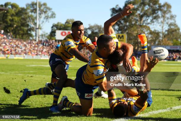 Bevan French, Jarryd Hayne and Josh Hoffman of the Eels tackle Josh Mansour of the Panthers into touch during the round one NRL match between the...