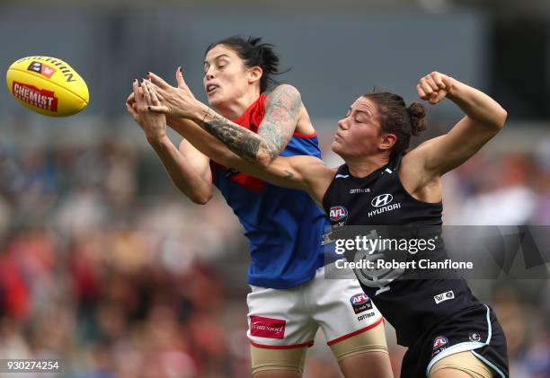 Tegan Cunningham of the Demons and Kate Gillespie-Jones of the Blues compete for the ball during the round six AFLW match between the Carlton Blues...