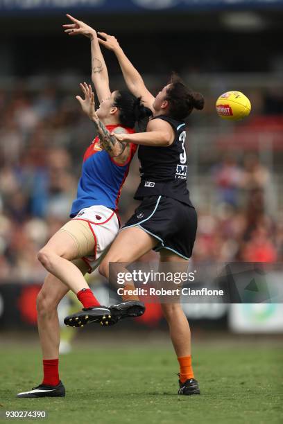 Tegan Cunningham of the Demons and Danielle Hardiman of the Blues compete for the ball during the round six AFLW match between the Carlton Blues and...