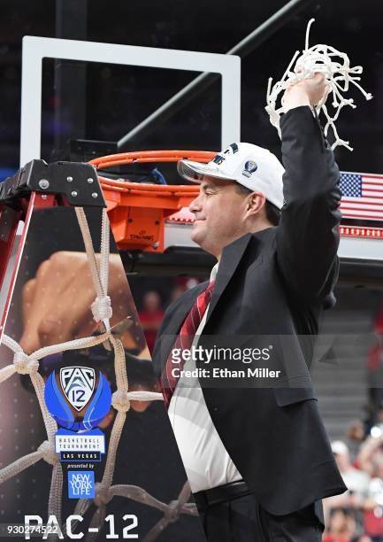 Head coach Sean Miller of the Arizona Wildcats cuts down a net after his team's 75-61 victory over the USC Trojans to win the championship game of...
