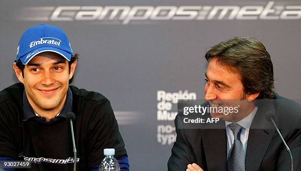 Brazilian Bruno Senna smiles next to Adrian Campos, Manager of the Campos Meta Formula One team, during a press conference for his official...