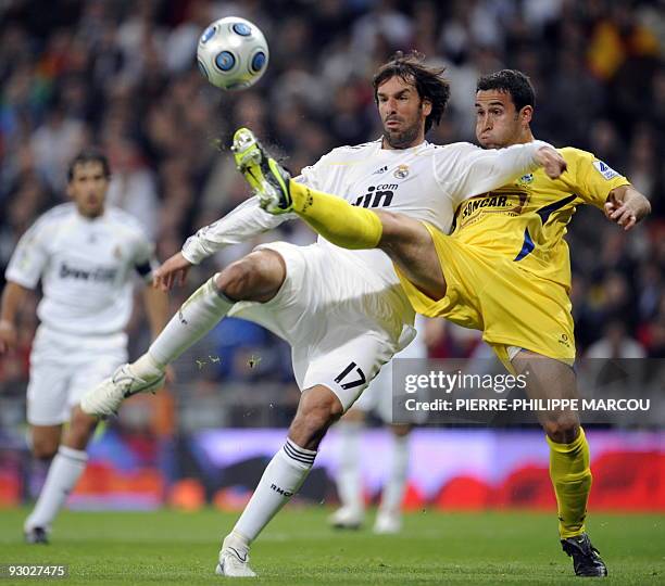 Real Madrid's Dutch forward Ruud van Nistelrooy vies with Alcorcon's Inigo Lopez during their King's Cup football match at Santiago Bernabeu stadium...