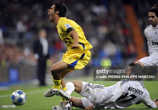 Real Madrid's Dutch forward Ruud van Nistelrooy vies with Alcorcon's Buben Sanz during their King's Cup football match at Santiago Bernabeu stadium...