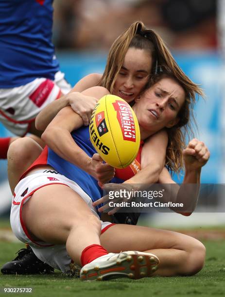 Cat Phillips of the Demons is challenged by Georgia Gee of the Blues during the round six AFLW match between the Carlton Blues and the Melbourne...