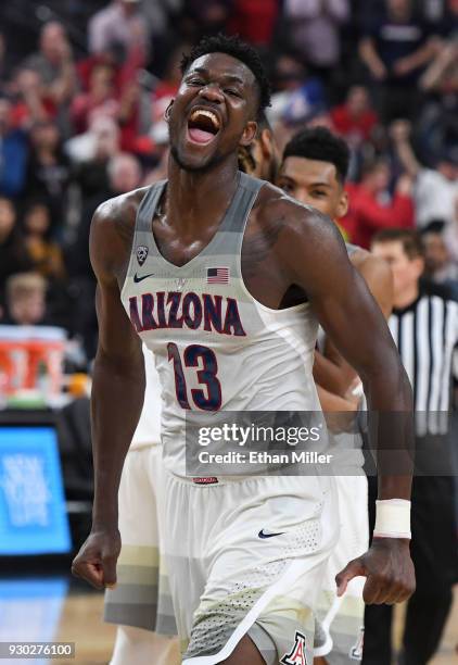 Deandre Ayton of the Arizona Wildcats celebrates on the court after the team defeated the USC Trojans 75-61 to win the championship game of the...