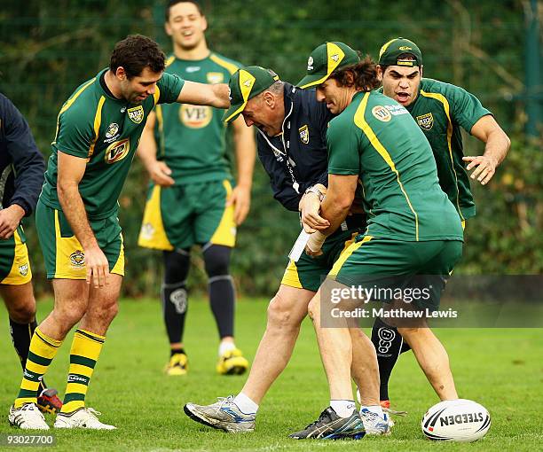 Tim Sheens is tackled by Nathan Hindmarsh of the VB Kangaroos Australian Rugby League Team during a training session at Leeds Rugby Academy on...