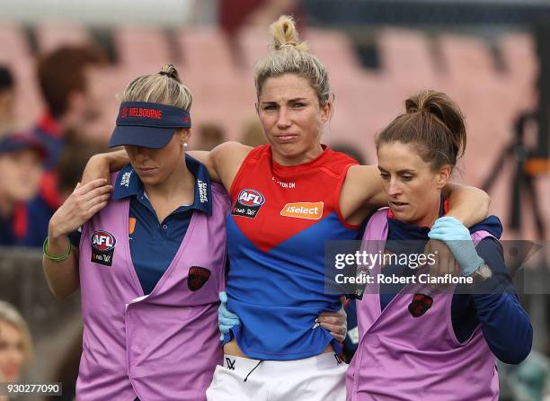 Melissa Hickey of the Demons leaves the ground with an injury during the round six AFLW match between the Carlton Blues and the Melbourne Demons at...