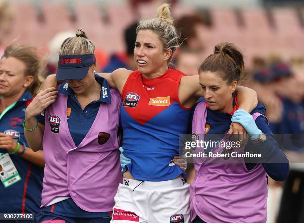 Melissa Hickey of the Demons leaves the ground with an injury during the round six AFLW match between the Carlton Blues and the Melbourne Demons at...
