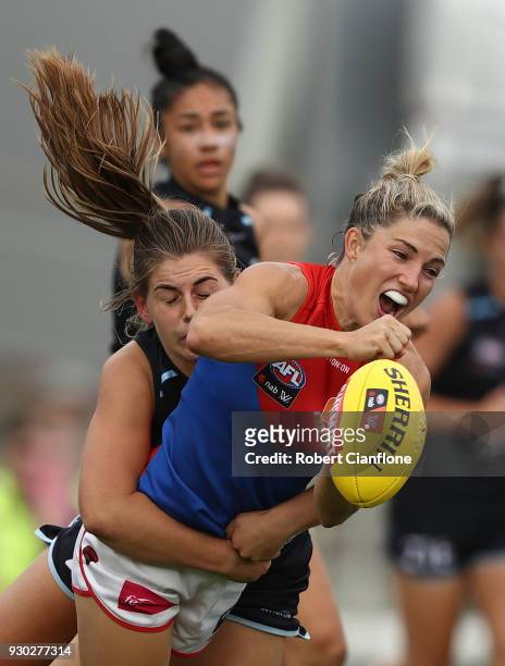 Melissa Hickey of the Demons is challenged by Madeline Keryk of the Blues during the round six AFLW match between the Carlton Blues and the Melbourne...