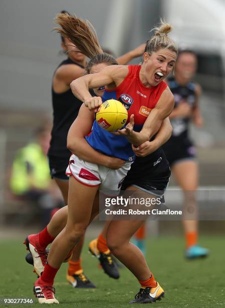 Melissa Hickey of the Demons is challenged by Madeline Keryk of the Blues during the round six AFLW match between the Carlton Blues and the Melbourne...