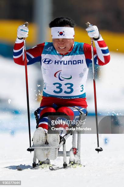 Vo Ra Mi Seo of Korea cries after crossing the finish line during the Women's Cross Country 12km - Sitting event at Alpensia Biathlon Centre during...