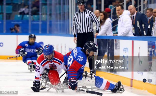 Dong Shin Jang of Korea battles for the puck with Zdenek Habl of Czech Republic in the Ice Hockey Preliminary Round - Group B game between Korea and...