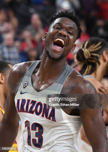 Deandre Ayton of the Arizona Wildcats celebrates on the court after the team defeated the USC Trojans 75-61 to win the championship game of the...