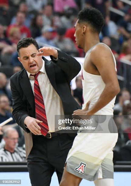 Head coach Sean Miller of the Arizona Wildcats congratulates Allonzo Trier during a timeout in the championship game of the Pac-12 basketball...