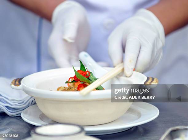 Summit-food-offbeat, by Philip Lim A chef prepares a special menu for delegates attending the Asia-Pacific Economic Cooperation forum in Singapore on...