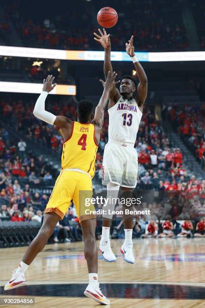 Deandre Ayton of the Arizona Wildcats handles the ball against Chimezie Metu of the USC Trojans during the championship game of the Pac-12 basketball...