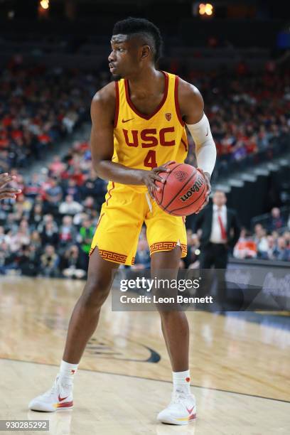 Chimezie Metu of the USC Trojans handles the ball against the Arizona Wildcats during the championship game of the Pac-12 basketball tournament at...