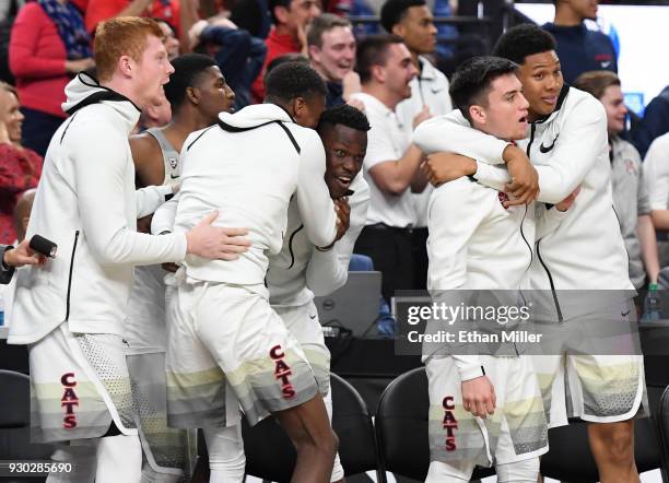 Players on the Arizona Wildcats bench react after a dunk by teammate Rawle Alkins against the USC Trojans in the second half of the championship game...