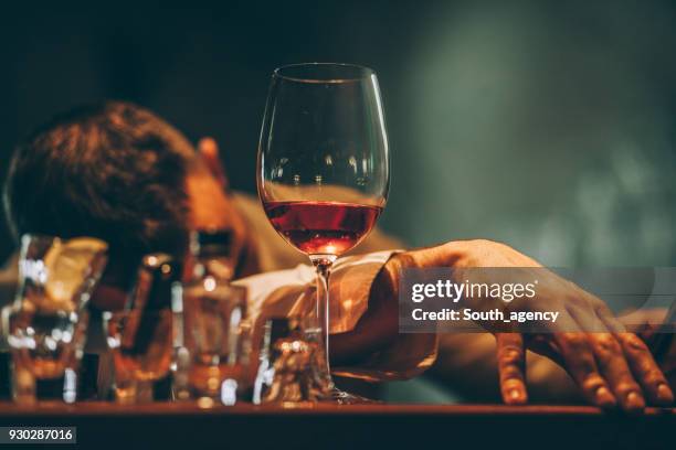 drunk young man sleeping in bar - binge drinking stock pictures, royalty-free photos & images