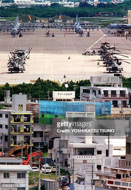 This September 1996 file picture shows US Marine attack helicopters and warplanes stationed at the Futenma Base, seen just behind the residential...