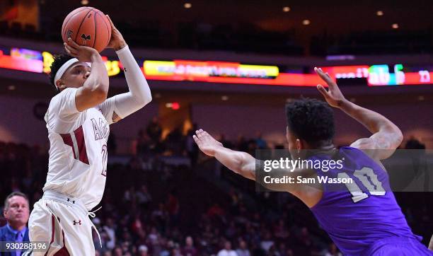 Zach Lofton of the New Mexico State Aggies shoots against Damari Milstead of the Grand Canyon Lopes during the championship game of the Western...